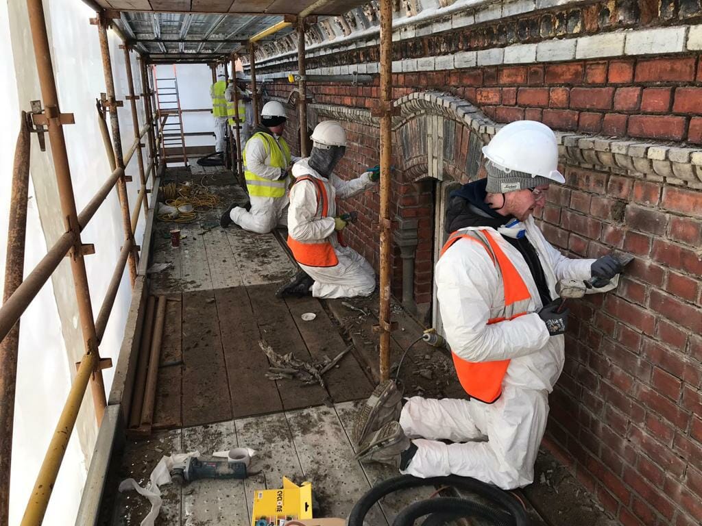PMAC operatives working on side elevations of building