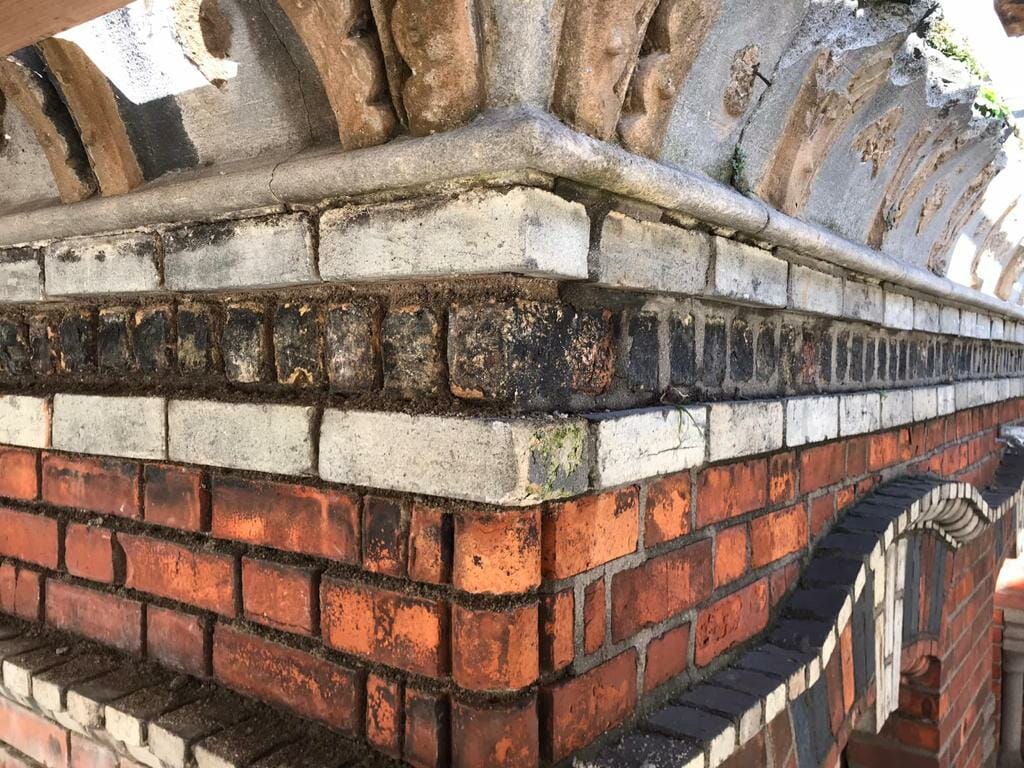 Side view of brickwork that is showing signs of damage