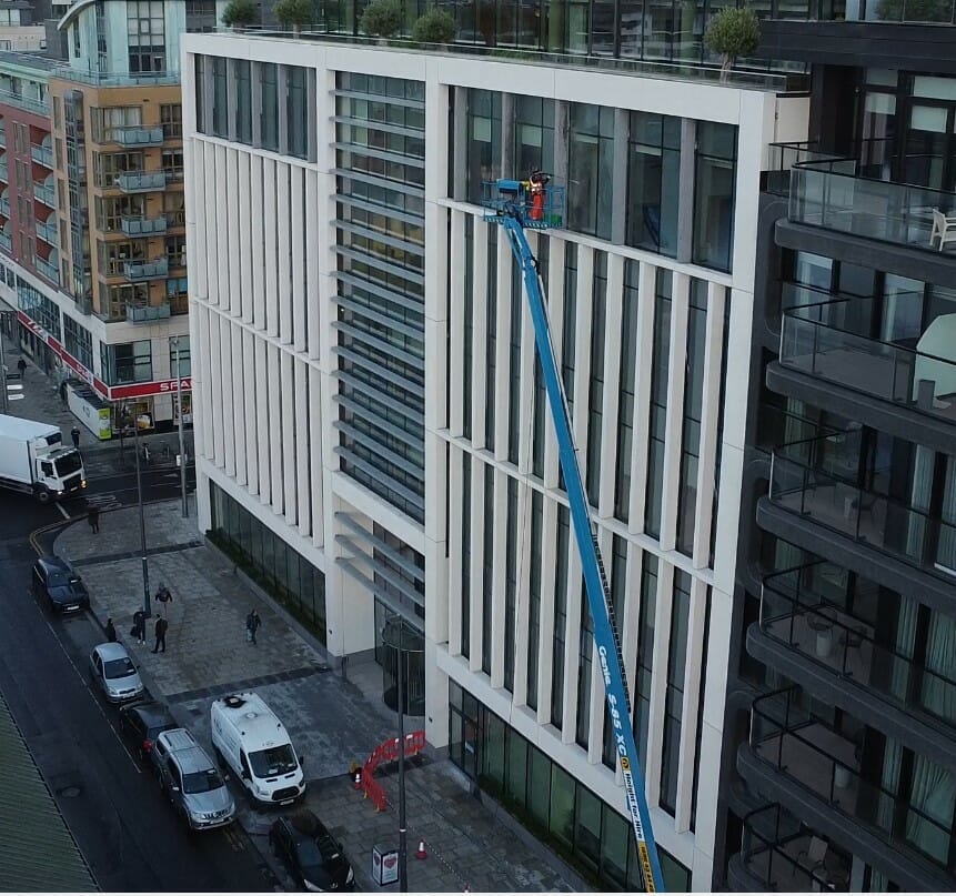Screenshot 2023-01-09 160831 Drone shot of operative cleaning deposits from windows from a hoist