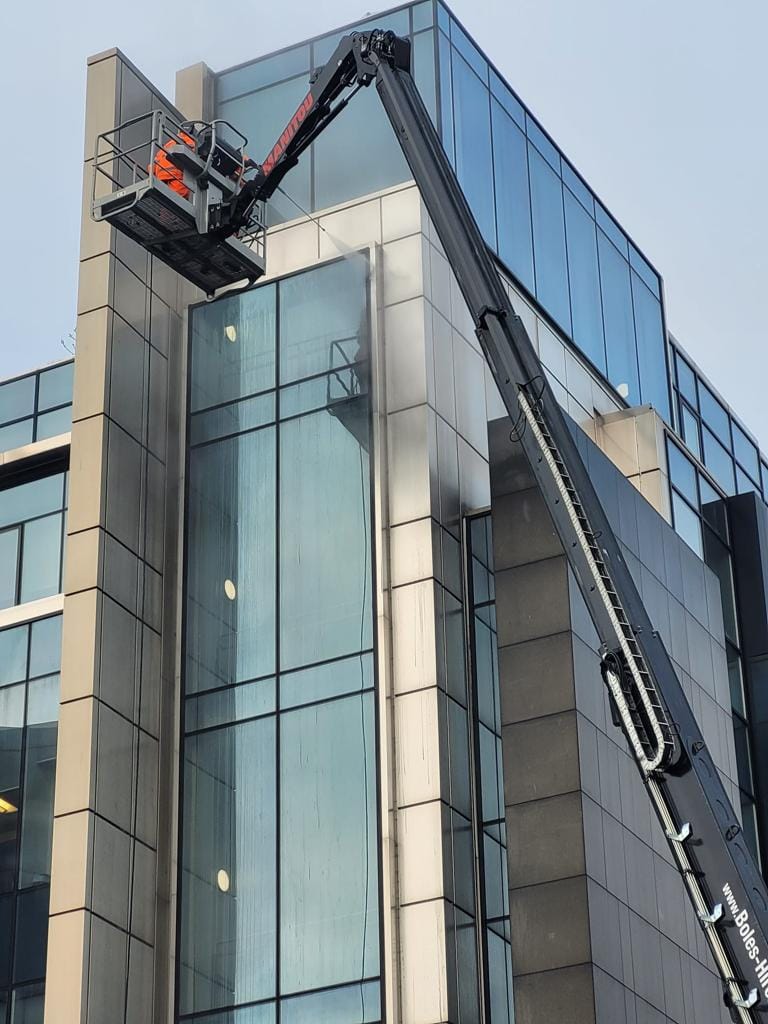 PMAC operatives cleaning Office building from a MEWP