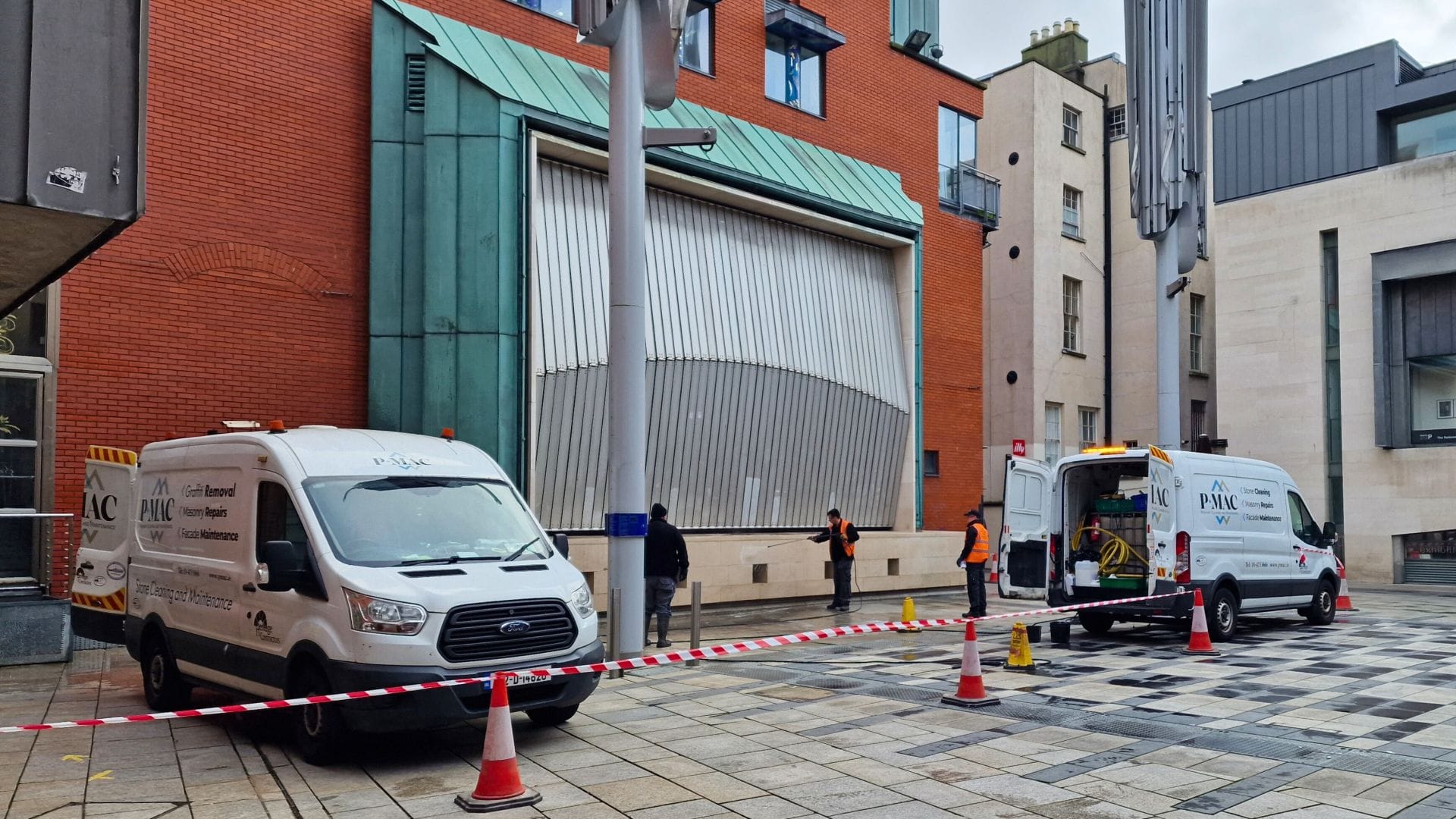 PMAC operatives removing graffiti from Temple bar in Dublin