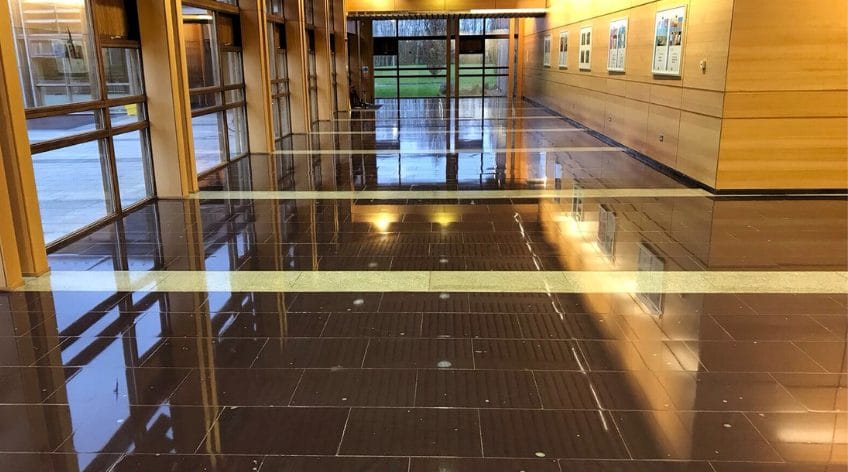 Stone floor reflecting natural light after been cleaned by PMAC floor team