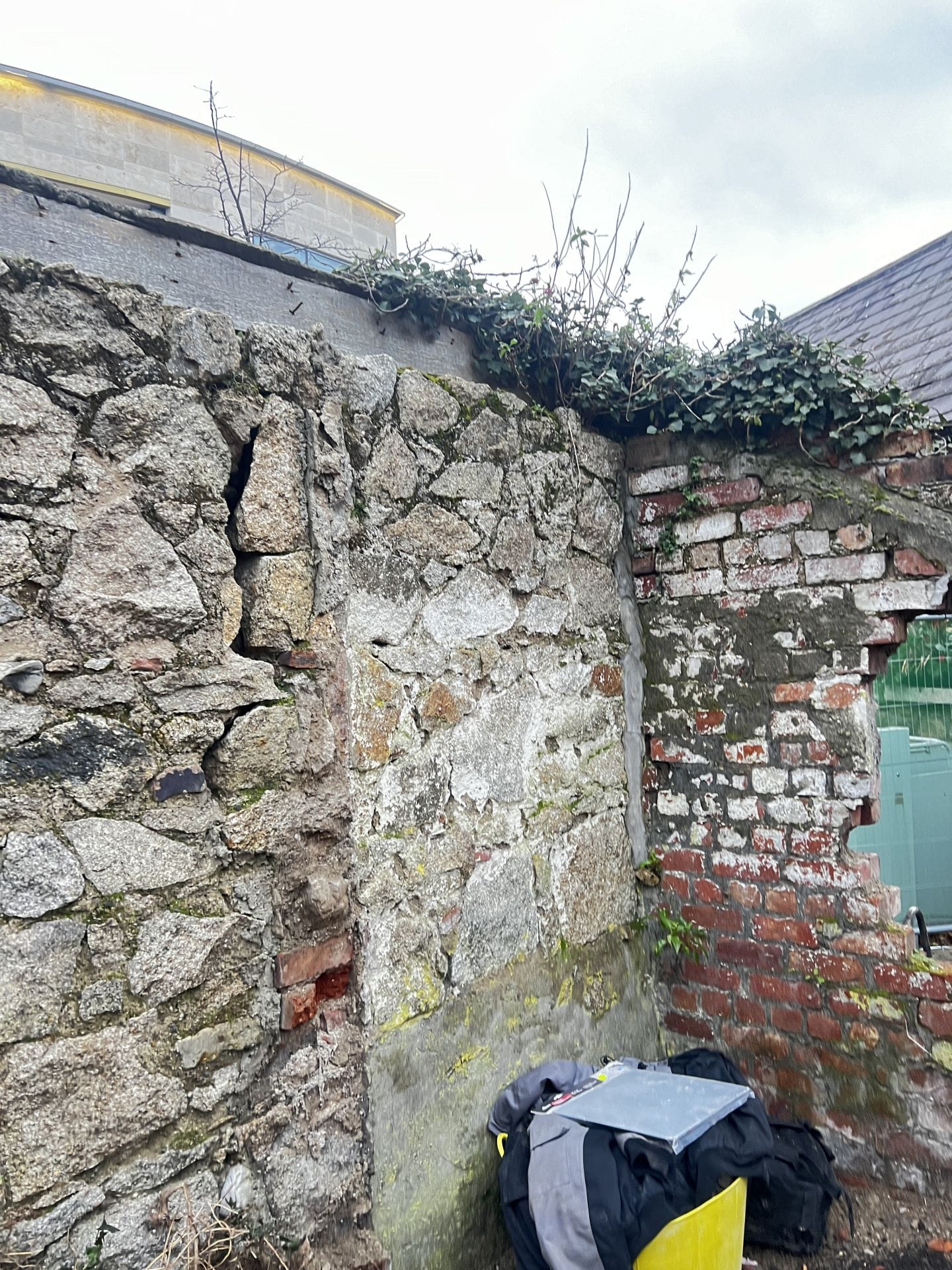 Old granite wall in state of disrepair Old granite wall in state of disrepair