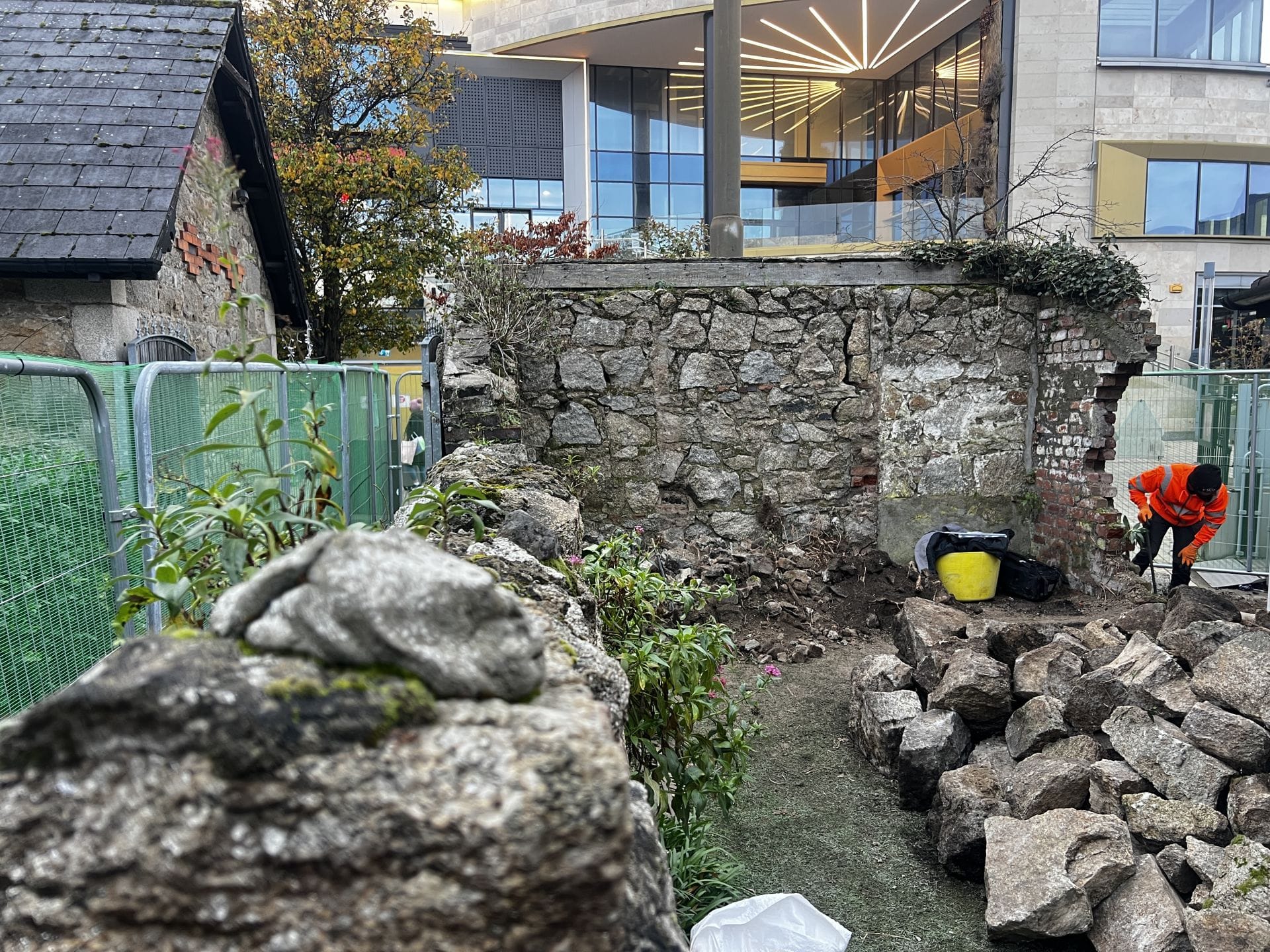 Salvaged granite stones to be recycled into the restored wall Salvaged granite stones to be recycled into the restored wall