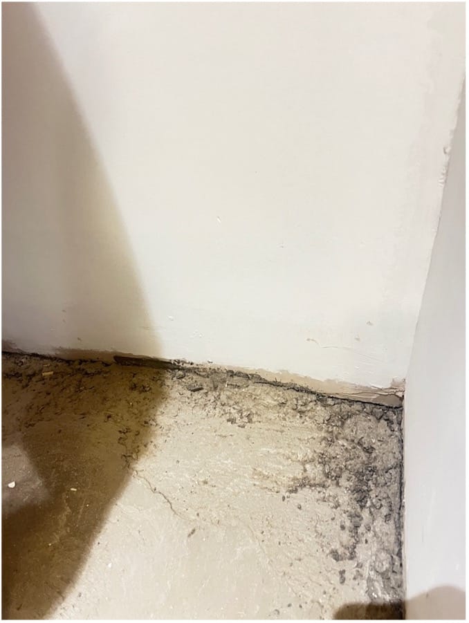 Unfinished corners on a badly poured concrete floor Unfinished corners on a badly poured concrete floor