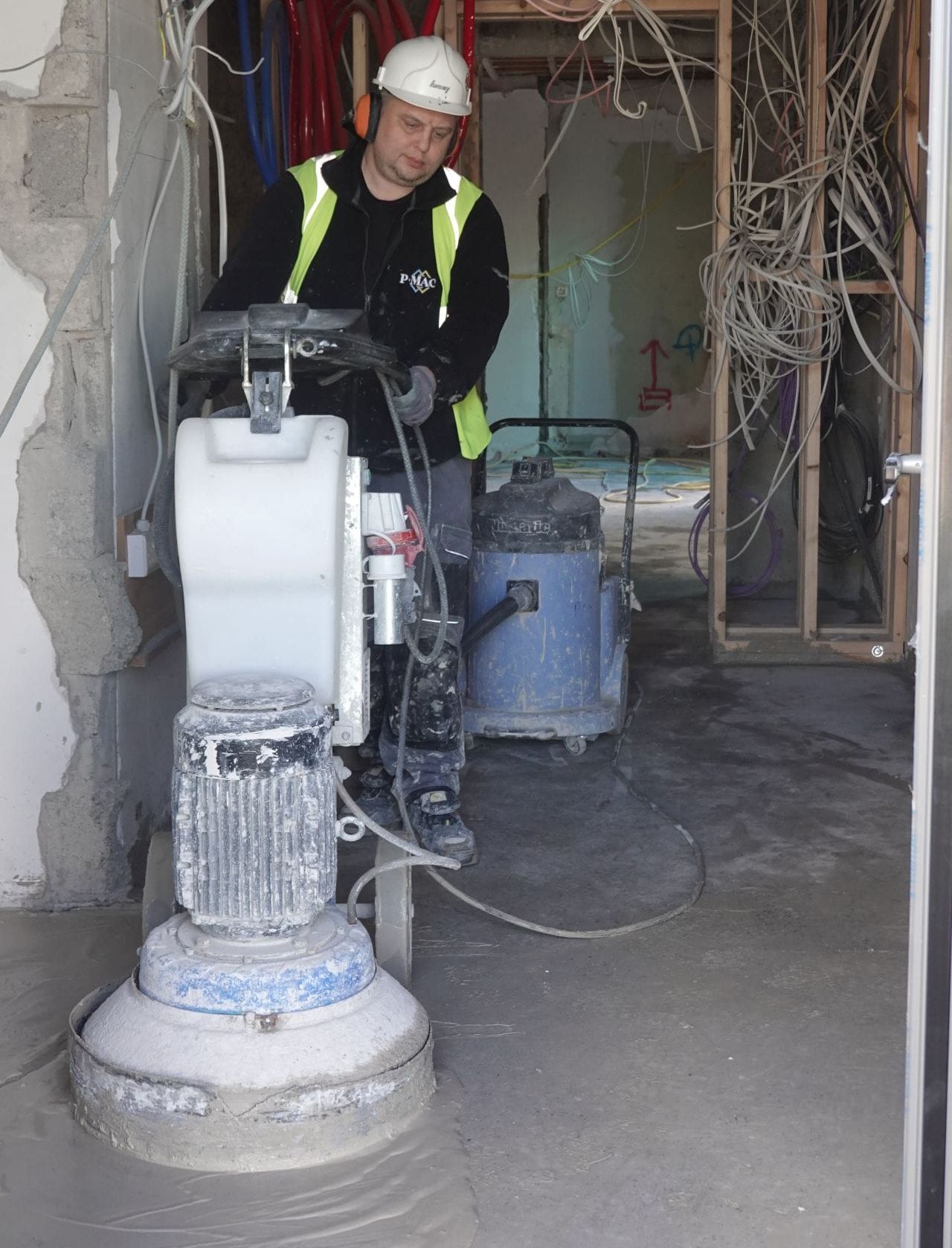 Initial grind, PMAC operative creating platinum polished concrete floor